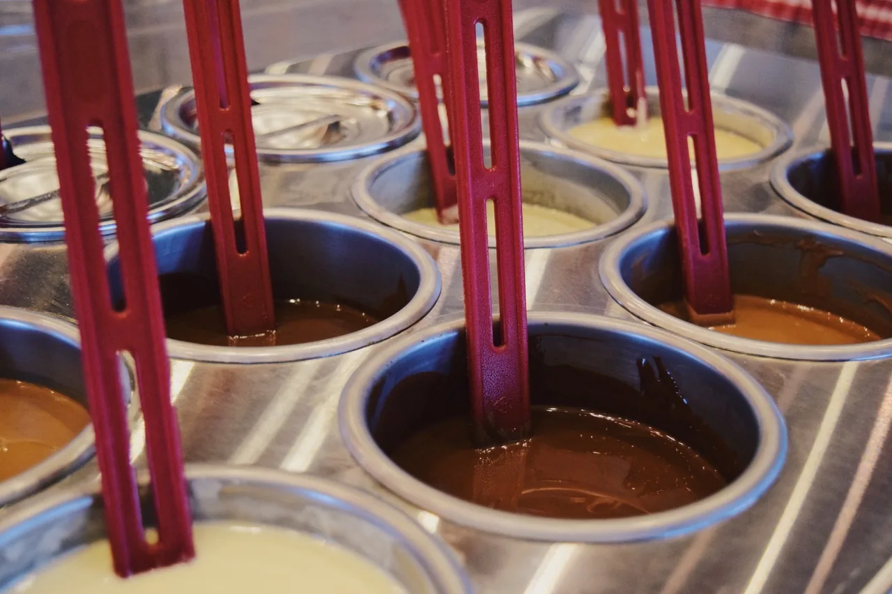 Les godets de la table à chocolat remplis de chocolat noir, au lait, blanc et caramel.